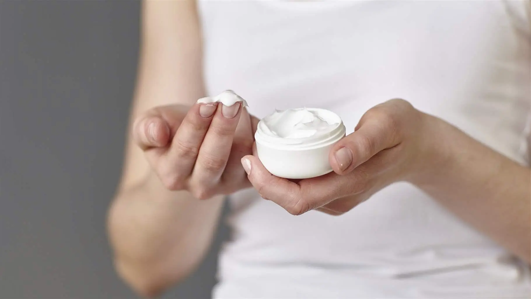 Woman rubbing compounded cream on her hand