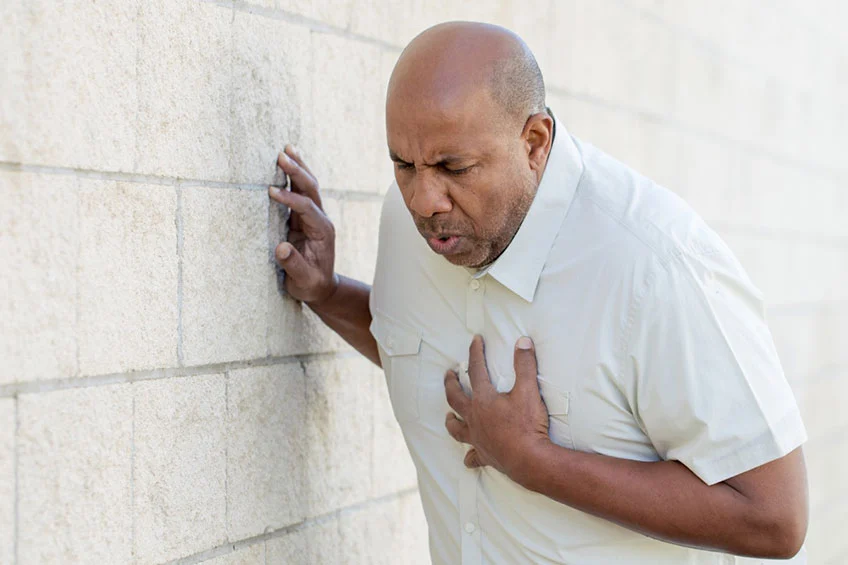 Old man suffering from heart attack in the street
