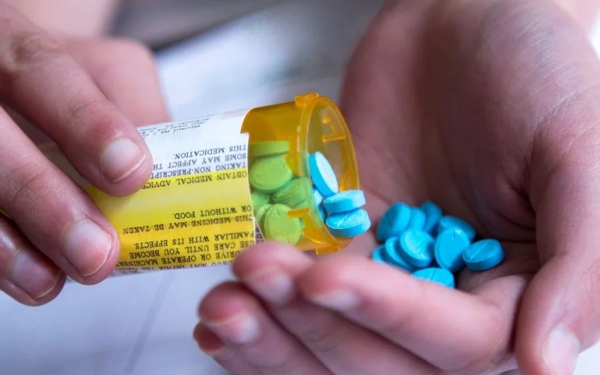 Prescription medicine being poured into hands