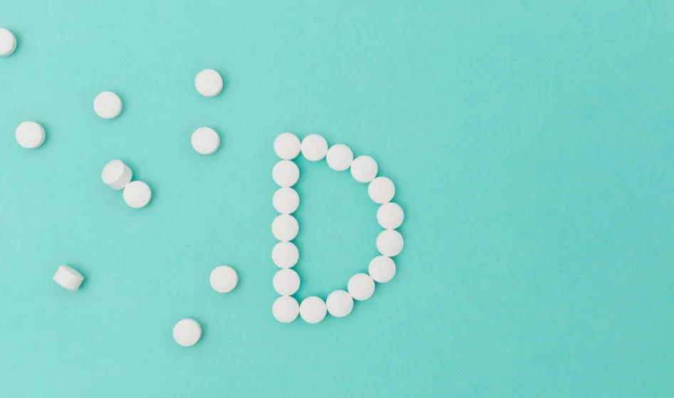 Vitamin D tablets with the letter "D" on a turquoise background