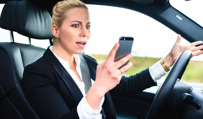 Woman Texting While Driving by Car
