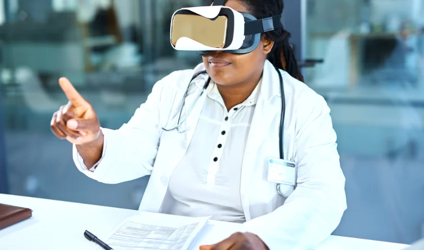Photo of a female doctor wearing a virtual reality headset while working in her office