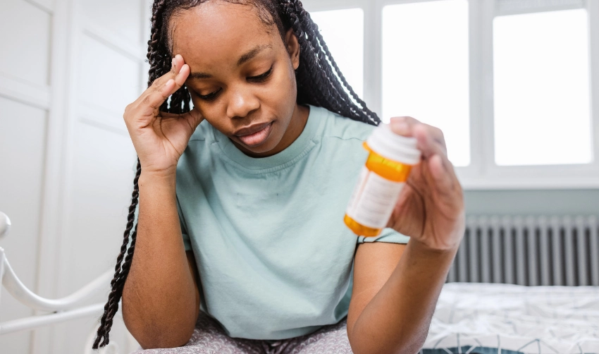 Young woman feels medication side effects