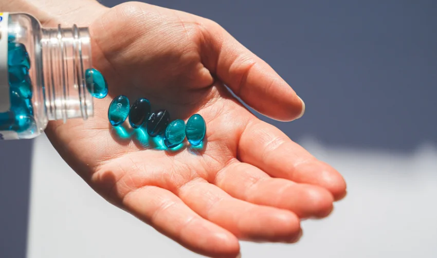 The person holding the blue pill