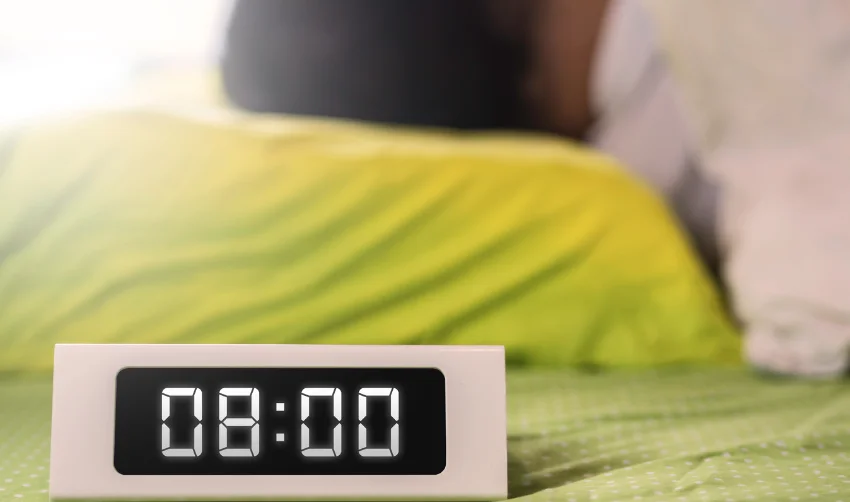 8 o'clock digital clock with a sleeping man