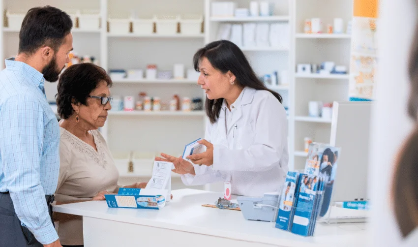 Female pharmacist explains dosage instructions to customer