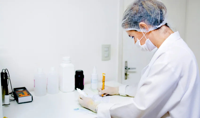 Woman working in a laboratory preparing chemical compounds
