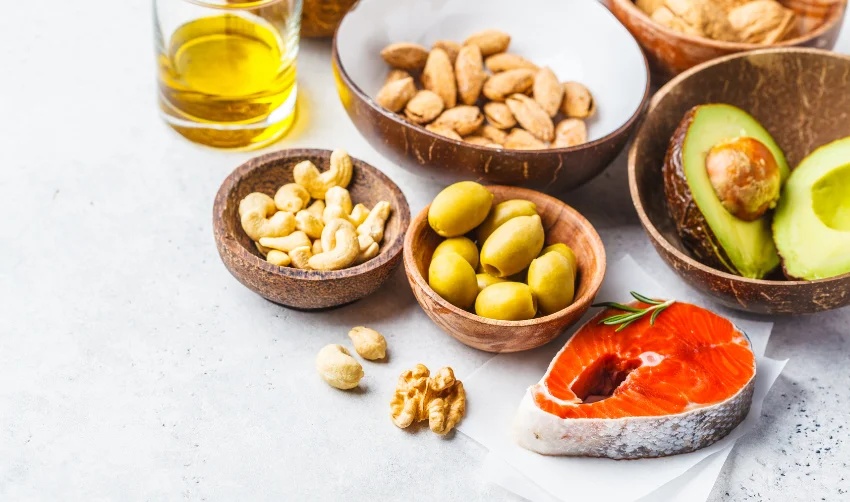 Fat healthy food background. Fish, nuts, oil, olives, avocados