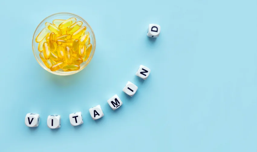 Yellow Capsules in the round Glass Bowl and the Word Vitamin D F