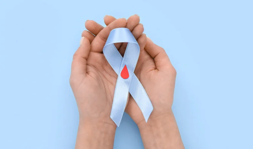 Woman with Awareness Ribbon on Blue Background. Diabetes Concept