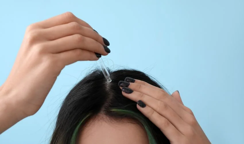 Young Woman Using Serum for Hair Loss Treatment on Color Background, Closeup