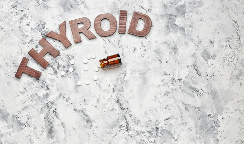 Wooden Letter for Thyroid and a Bottle of Pills