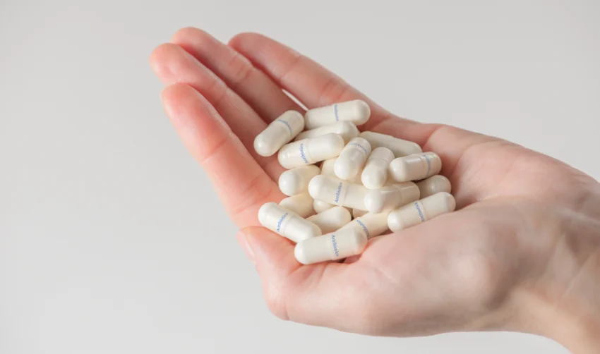 a Woman Is Holding a Handful of Antibiotics